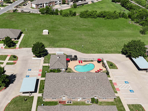 A large building with a pool in front of it.