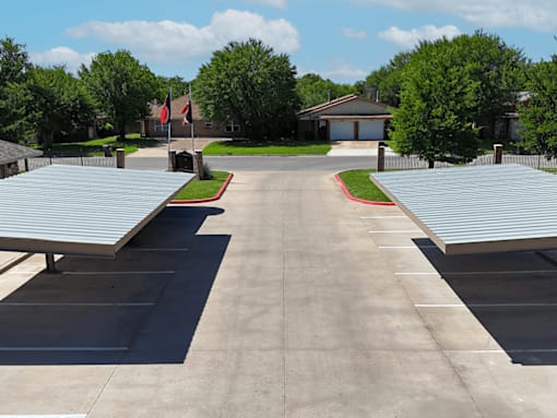 A parking lot with a building in the background.