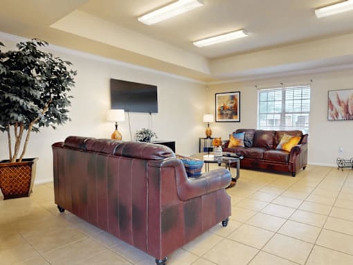 A living room with a red couch and a television.