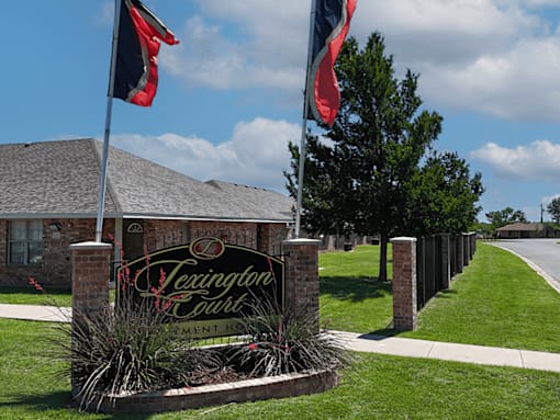 A sign for Texington Court sits in front of a building.