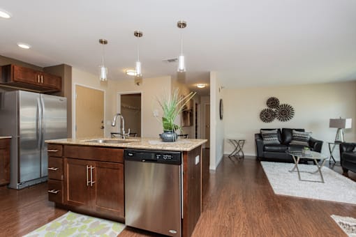 A modern kitchen with stainless steel appliances and wooden cabinets.