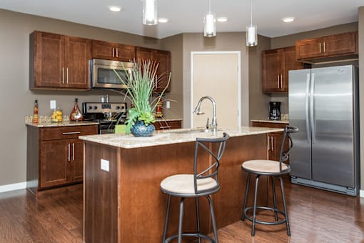 A kitchen with a bar stool and a counter.