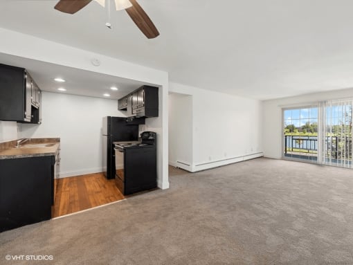 living room with a kitchen and a balcony