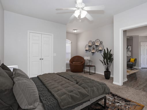 a bedroom with a bed and a ceiling fan