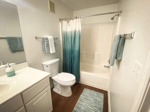 A white toilet sits next to a sink in a bathroom.