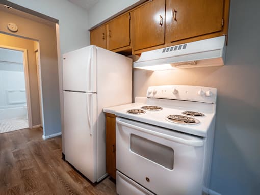 A white refrigerator and stove in a kitchen.