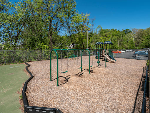 A playground with swings and a slide.