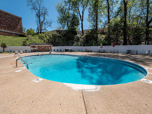 A small pool with a white fence around it.