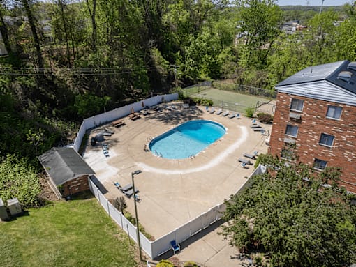 A small pool surrounded by a white fence.