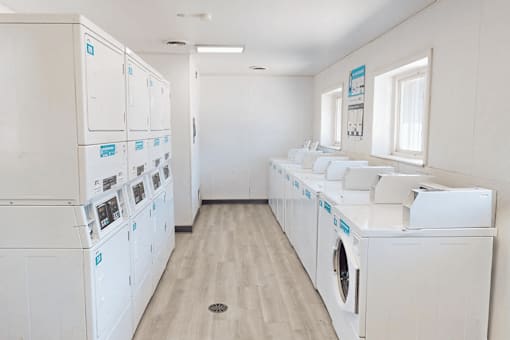 A row of washing machines in a laundromat.