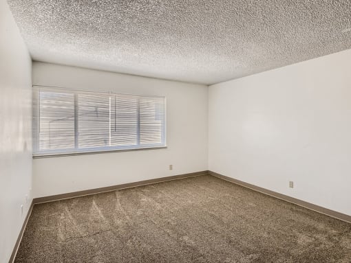 Living room with large window at mesa gardens apartments