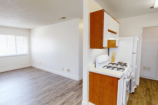 A kitchen with a white fridge and a white stove.