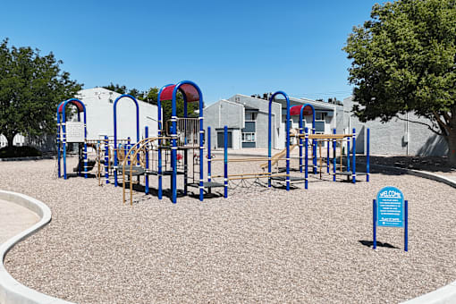 A playground with a blue sign that says