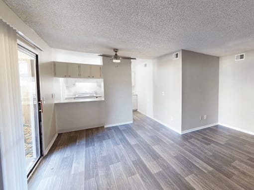A room with a sliding glass door and a window.