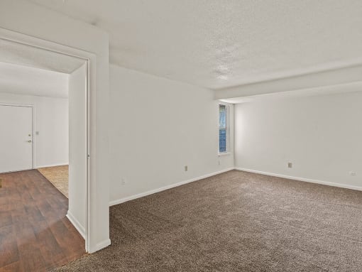 a empty rooms with carpeted flooring and white walls