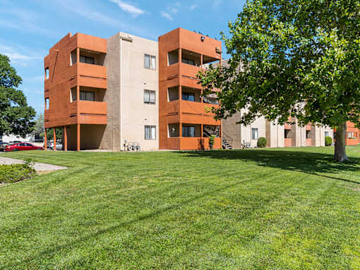 A large building with a green lawn in front.