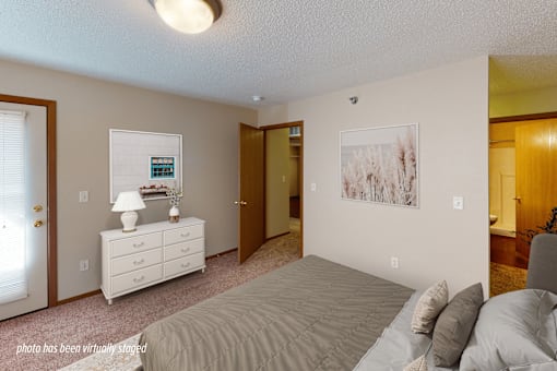 A bedroom with a bed, dresser, and two pictures on the wall.