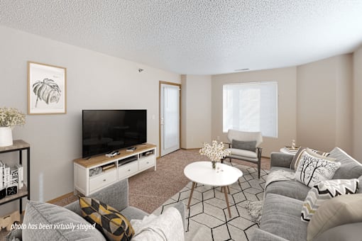 A living room with a television, a chair, a sofa, and a coffee table.