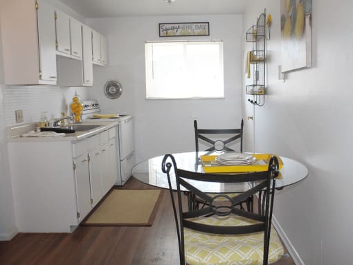 a small kitchen with a table and chairs and a sink