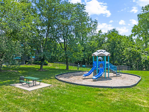 a playground with a blue swing set