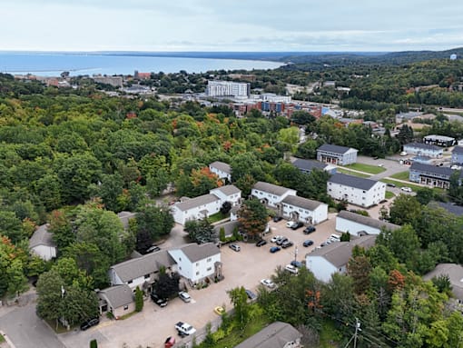 A bird's eye view of a residential area with houses and cars.