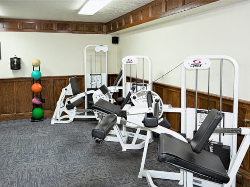 a room with a bunch of exercise equipment in it