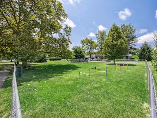 A dog park onsite at an apartment with a dog agility course