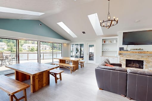 A modern living room with a fireplace and a large wooden table.