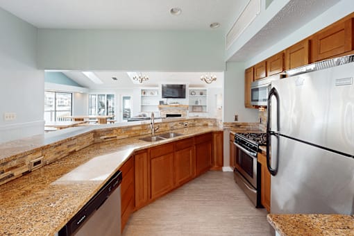 A kitchen with granite countertops and stainless steel appliances.