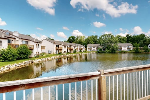 A row of houses are situated by a body of water.