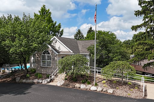 A house with a flag on a pole in front of it.