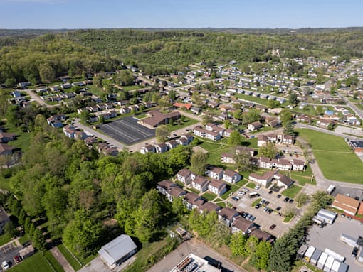 A bird's eye view of a residential area with houses and greenery.