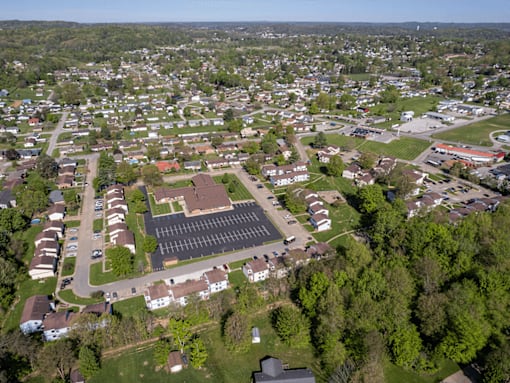 A bird's eye view of a residential area with a large building in the center.