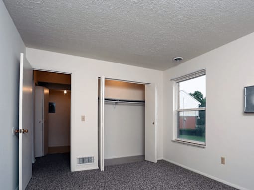 A room with a sliding door and a window.