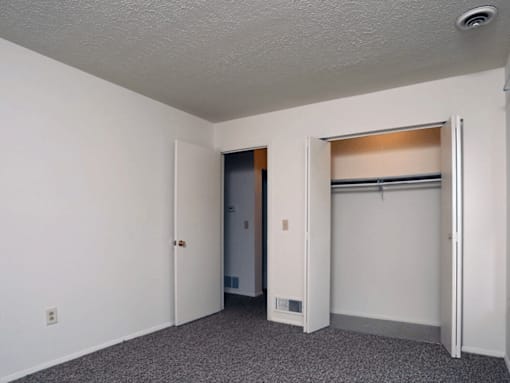 A room with a white door and a white wall.
