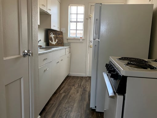 a kitchen with a stove refrigerator and sink