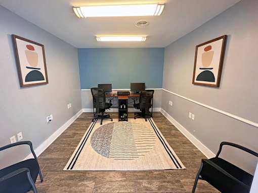 A room with a blue wall and a striped rug on the floor.