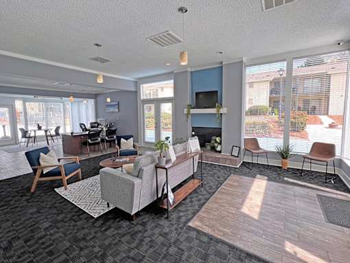 A living room with a grey couch and a wooden chair.