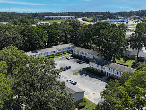A bird's eye view of a residential area with houses and trees.