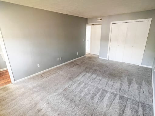 an empty room with a carpeted floor