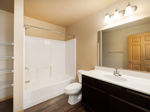A bathroom with a toilet, sink, and shower.