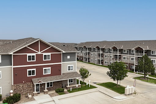 Apartment complex with a red building in the foreground.