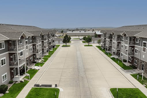 A long road in a residential area with houses on both sides.