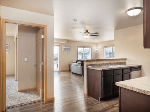 A kitchen with a brown counter top and a ceiling fan.