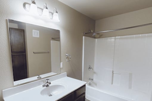 A white sink with a mirror above it.