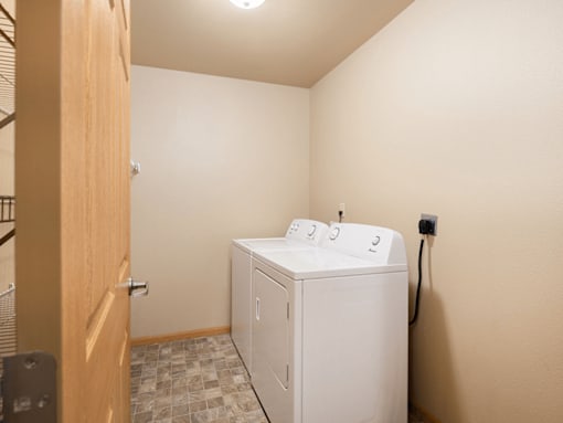 A white washing machine in a small room.