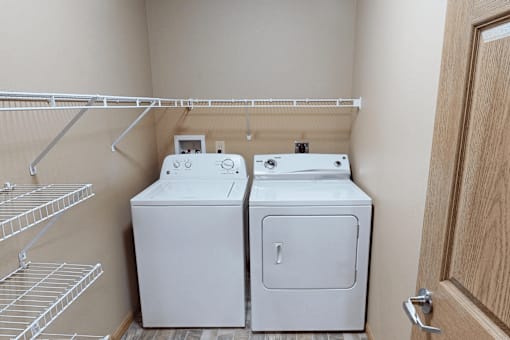A small laundry room with a washer and dryer.