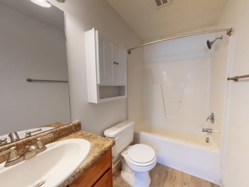 a bathroom with a sink toilet and a bath tub