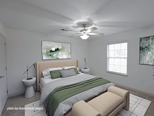A bedroom with a bed, a chair, and a painting on the wall.