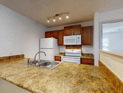 a kitchen with a large counter top and a sink